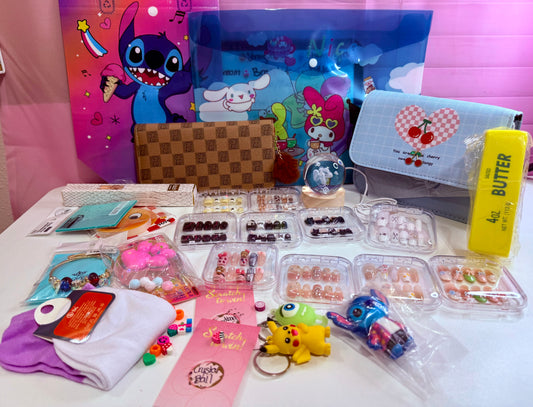 Decorated press-on nail sets in clear cases with pouches, character bags, socks and keychains on a table.